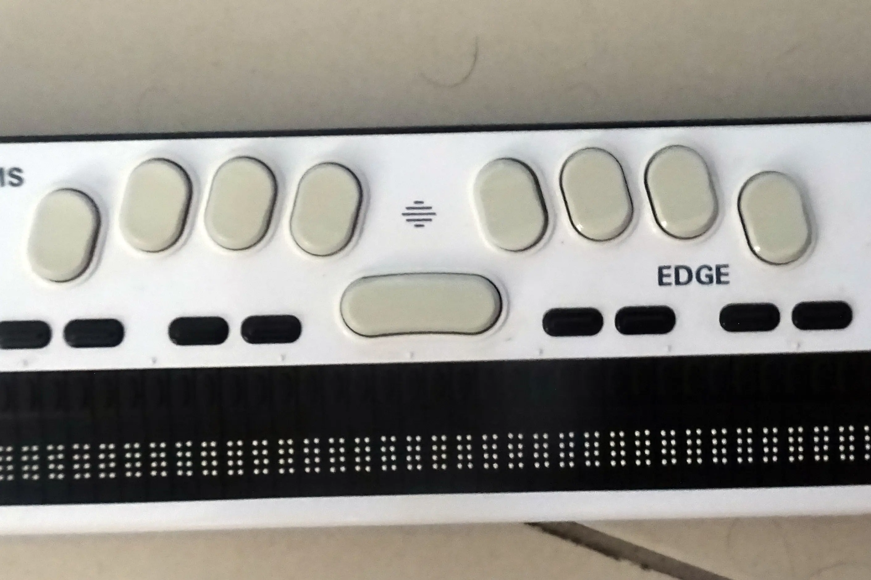 Close-up of a refreshable braille display device showing raised dot cells