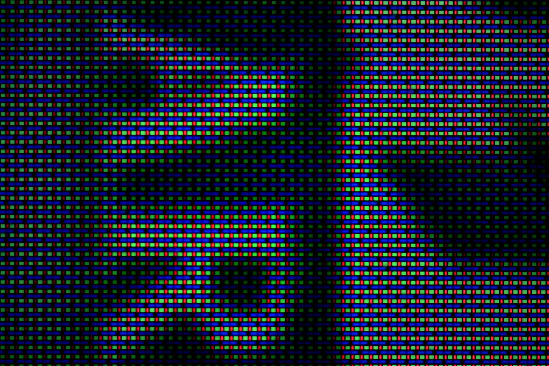 Microscope close up of a Nintendo Switch OLED screen showing red, green and blue subpixels