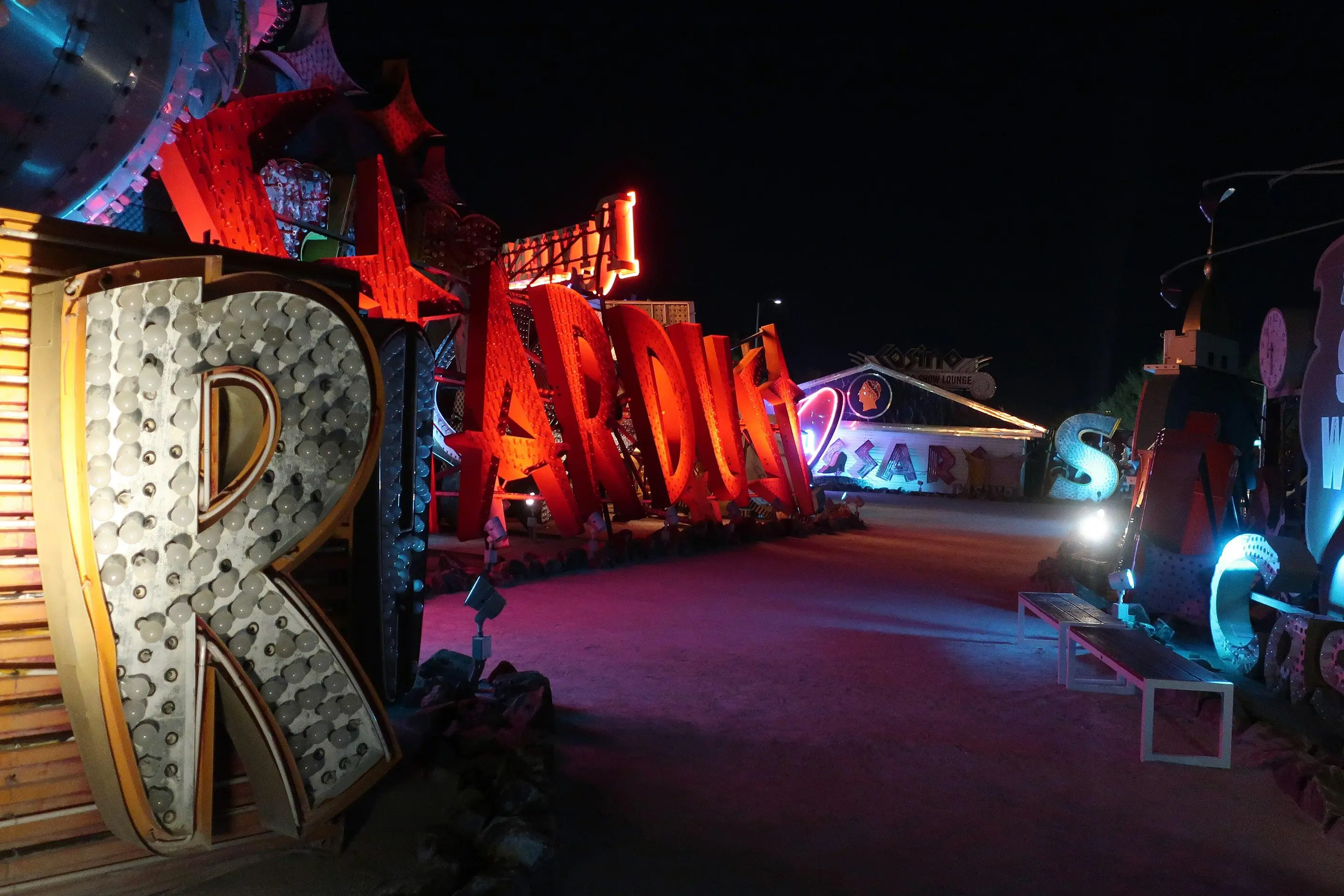 Vintage neon signs glowing red pink and blue at the Neon Museum boneyard in Las Vegas