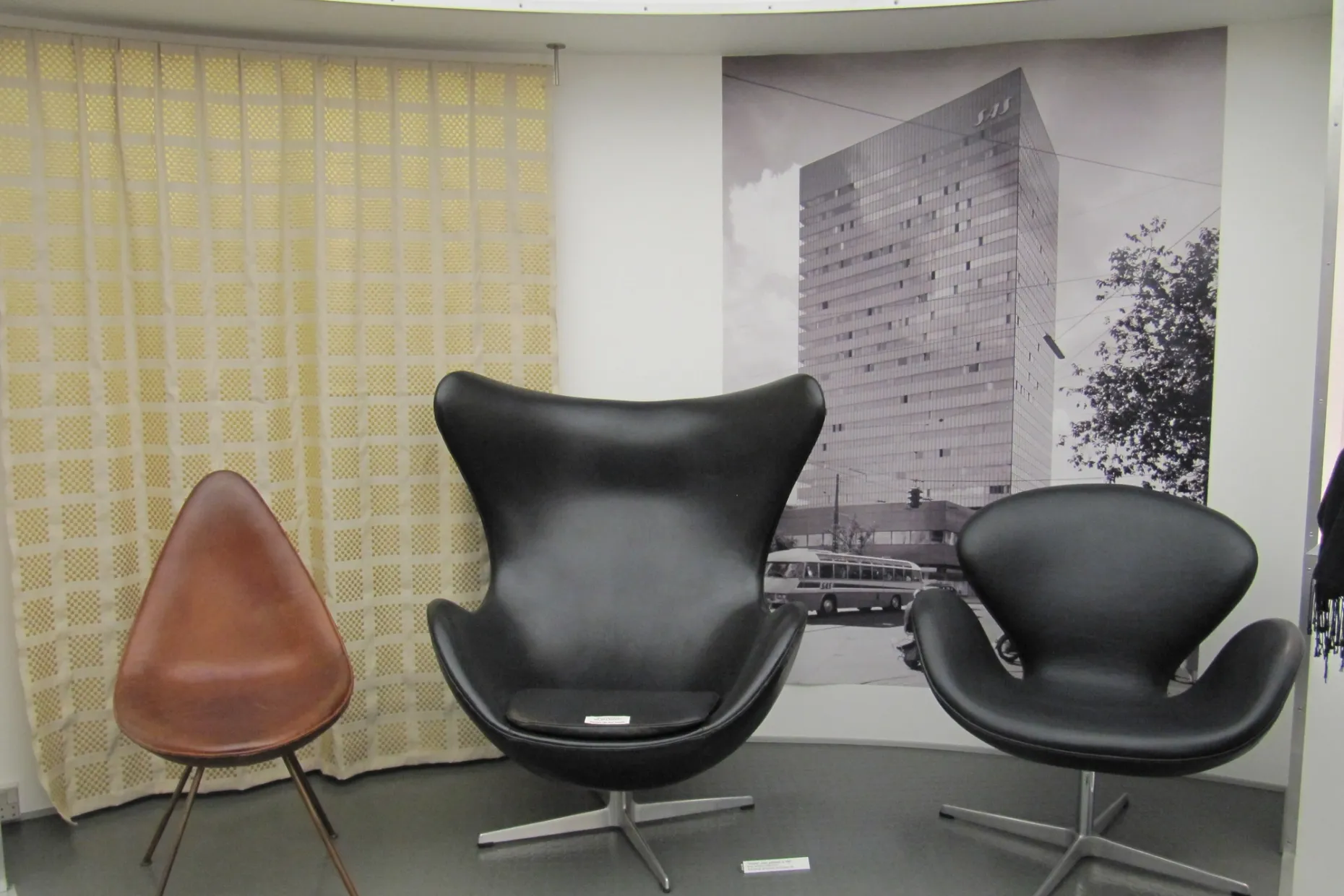 Arne Jacobsen's Drop, Egg and Swan chairs displayed together in leather upholstery