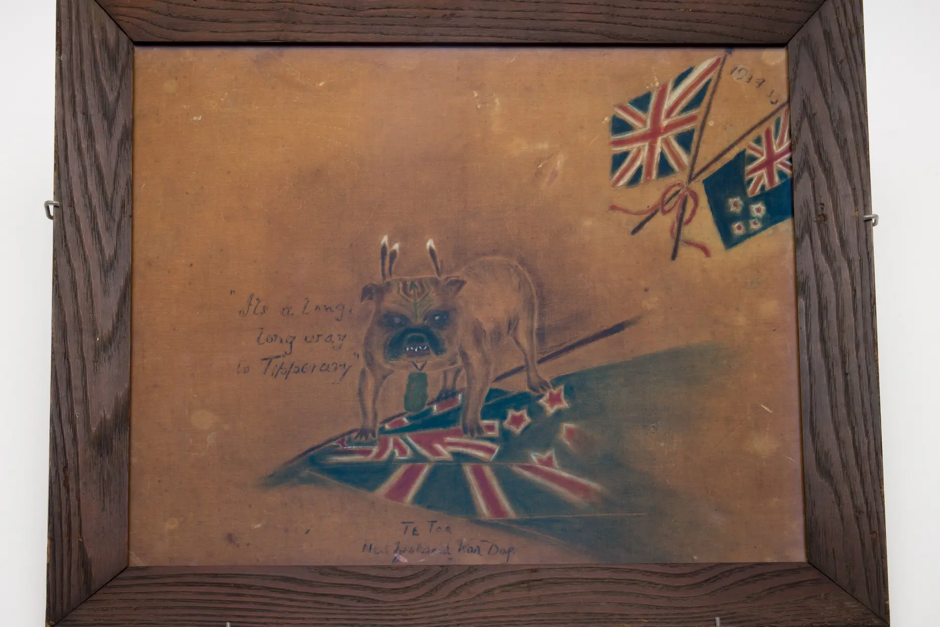 A velvet painting of a bulldog draped in British and New Zealand flags