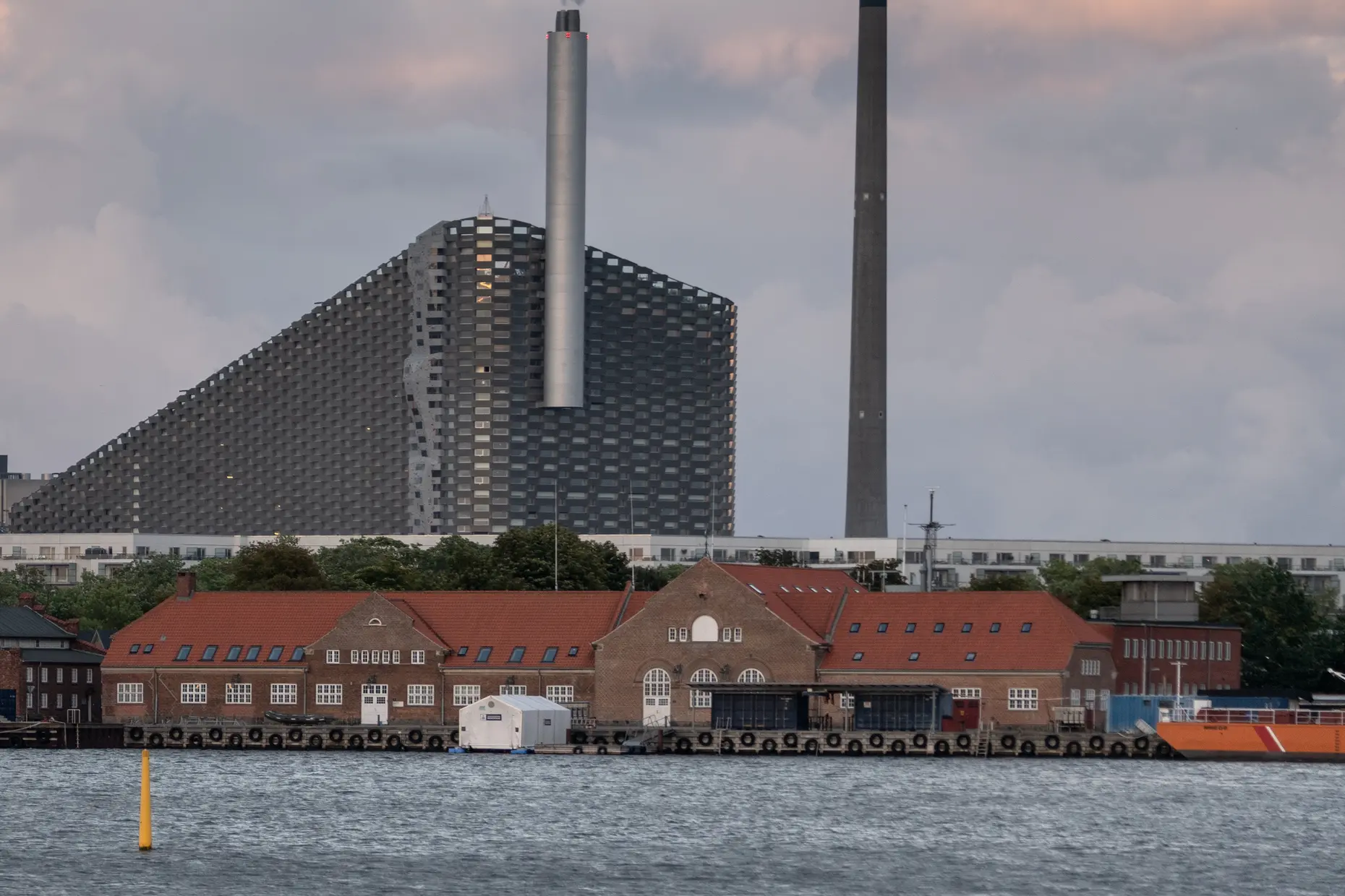 CopenHill waste to energy plant with a sloped facade and rooftop ski slope in Copenhagen