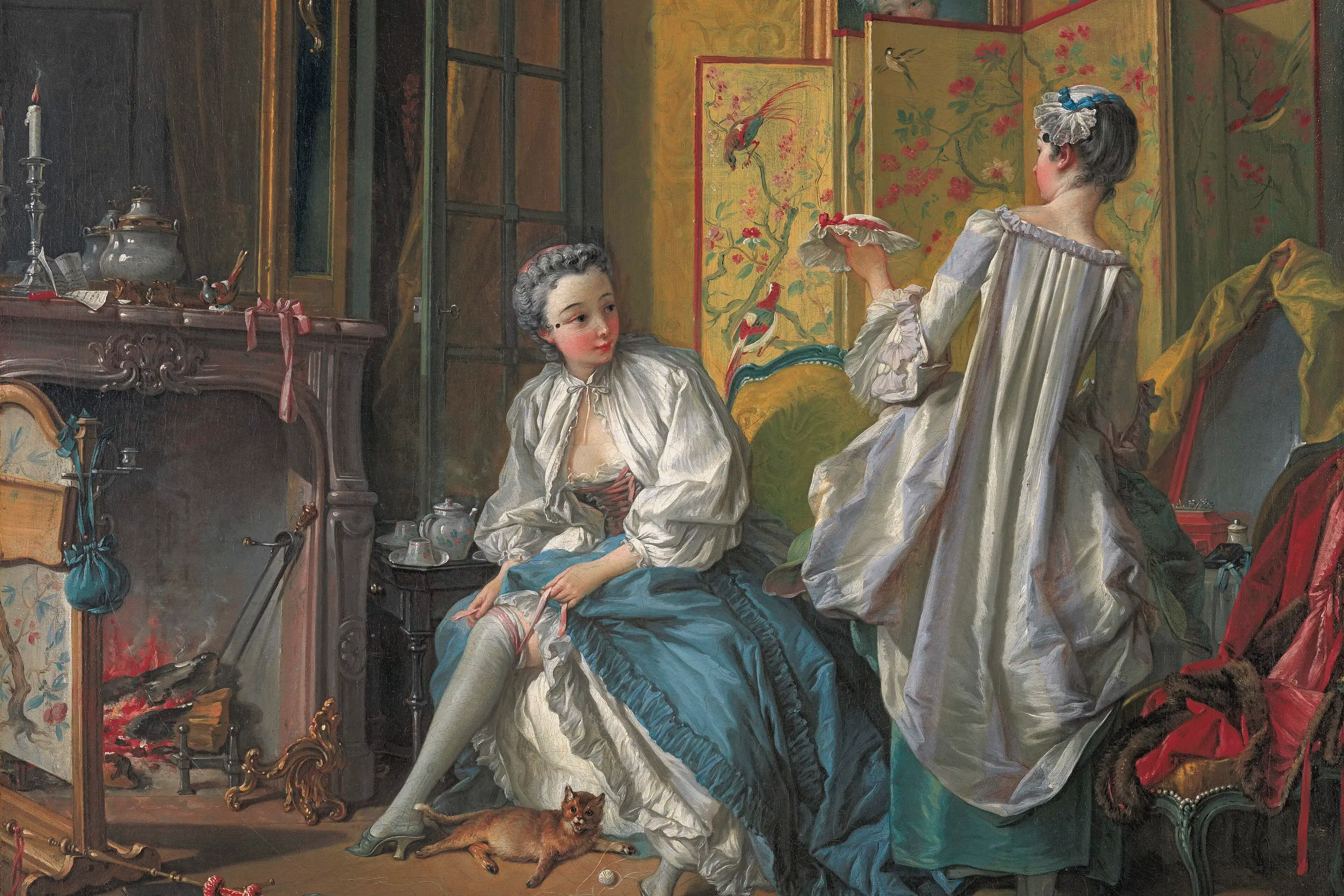 A Rococo interior with two women dressing among silks, a painted screen, ribbons and a cat