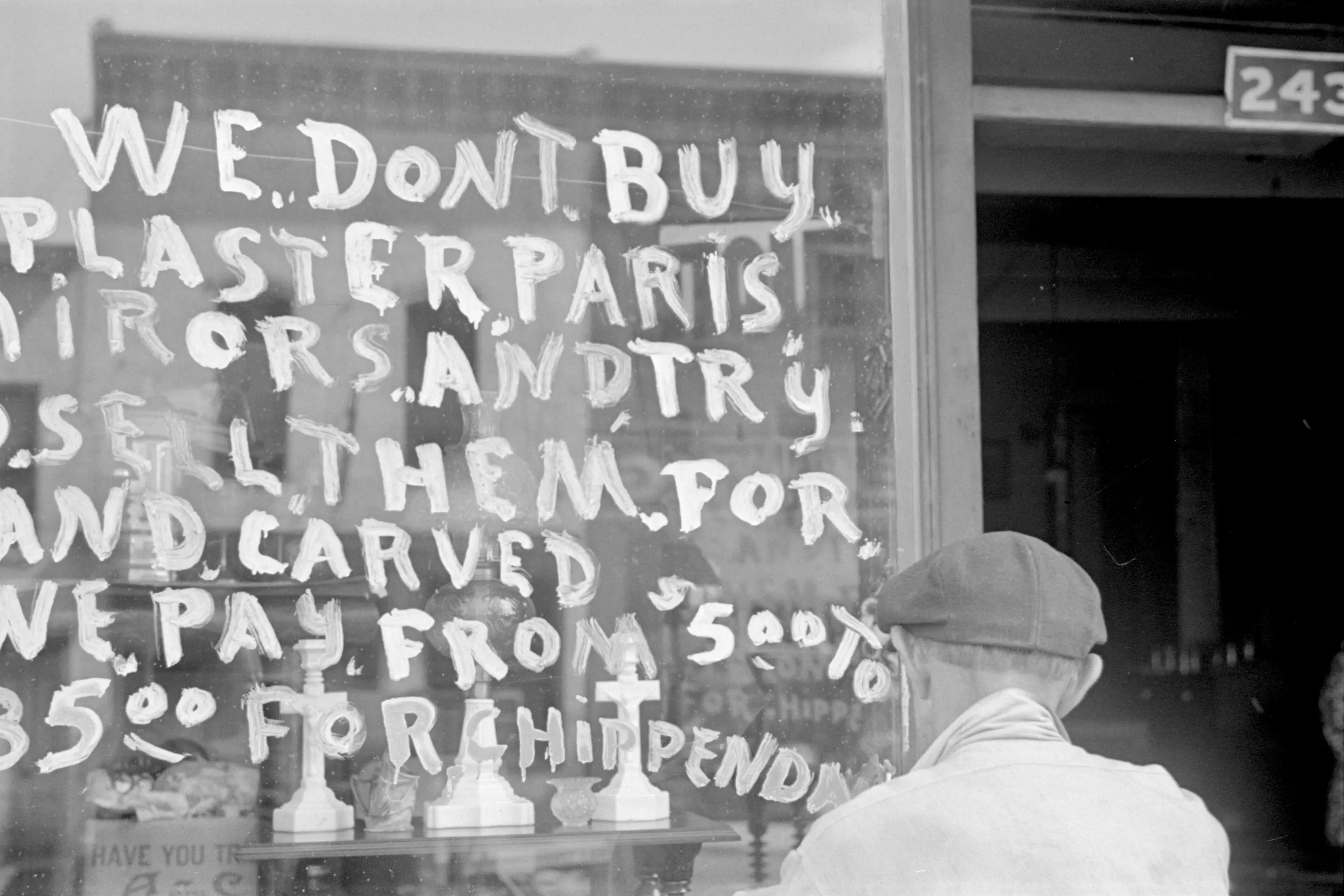 Hand brushed shop window sign reading We Dont Buy Plaster Paris Mirors And Try