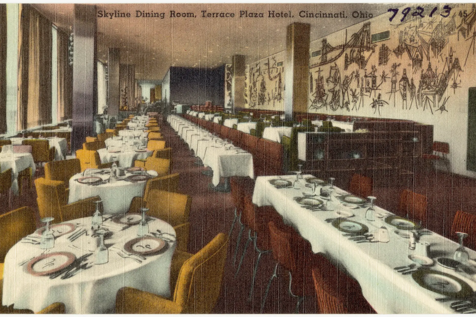 A hand-tinted postcard of a long hotel dining room, its walls covered in Saul Steinberg's line-drawn mural of city life