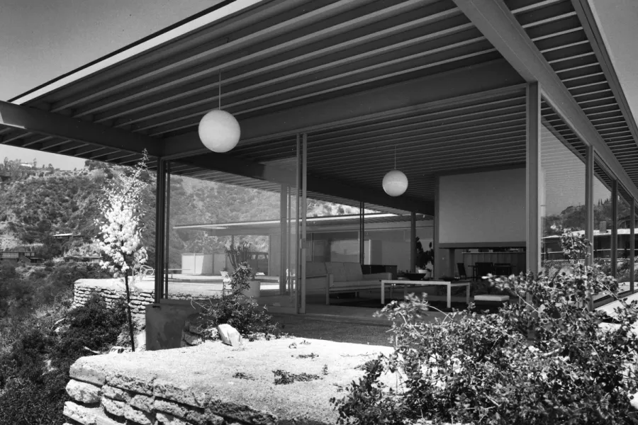 Cantilevered mid-century house with floor to ceiling glass and a hillside view