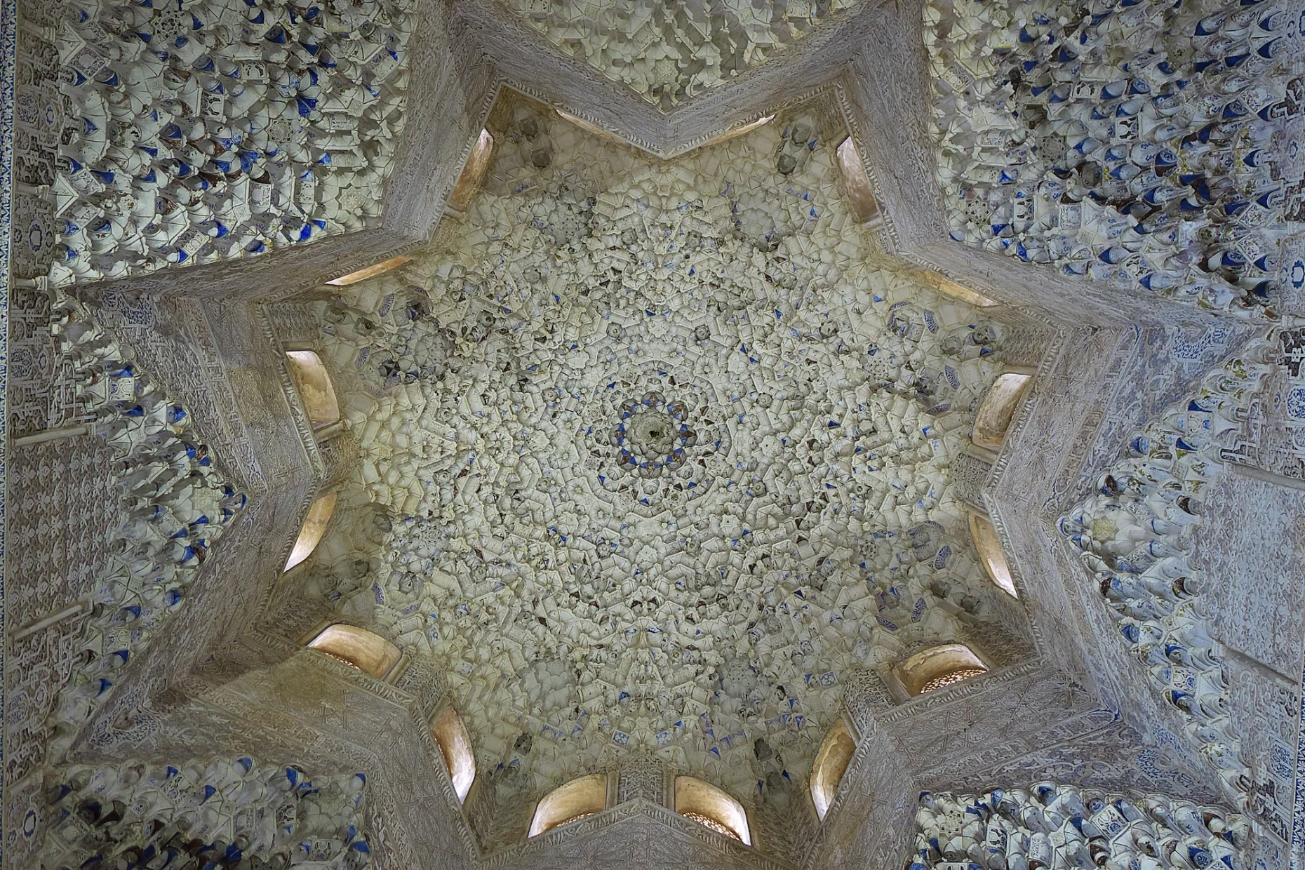 Muqarnas vault shaped as an eight-pointed star, honeycomb cells in carved stucco lit by small windows