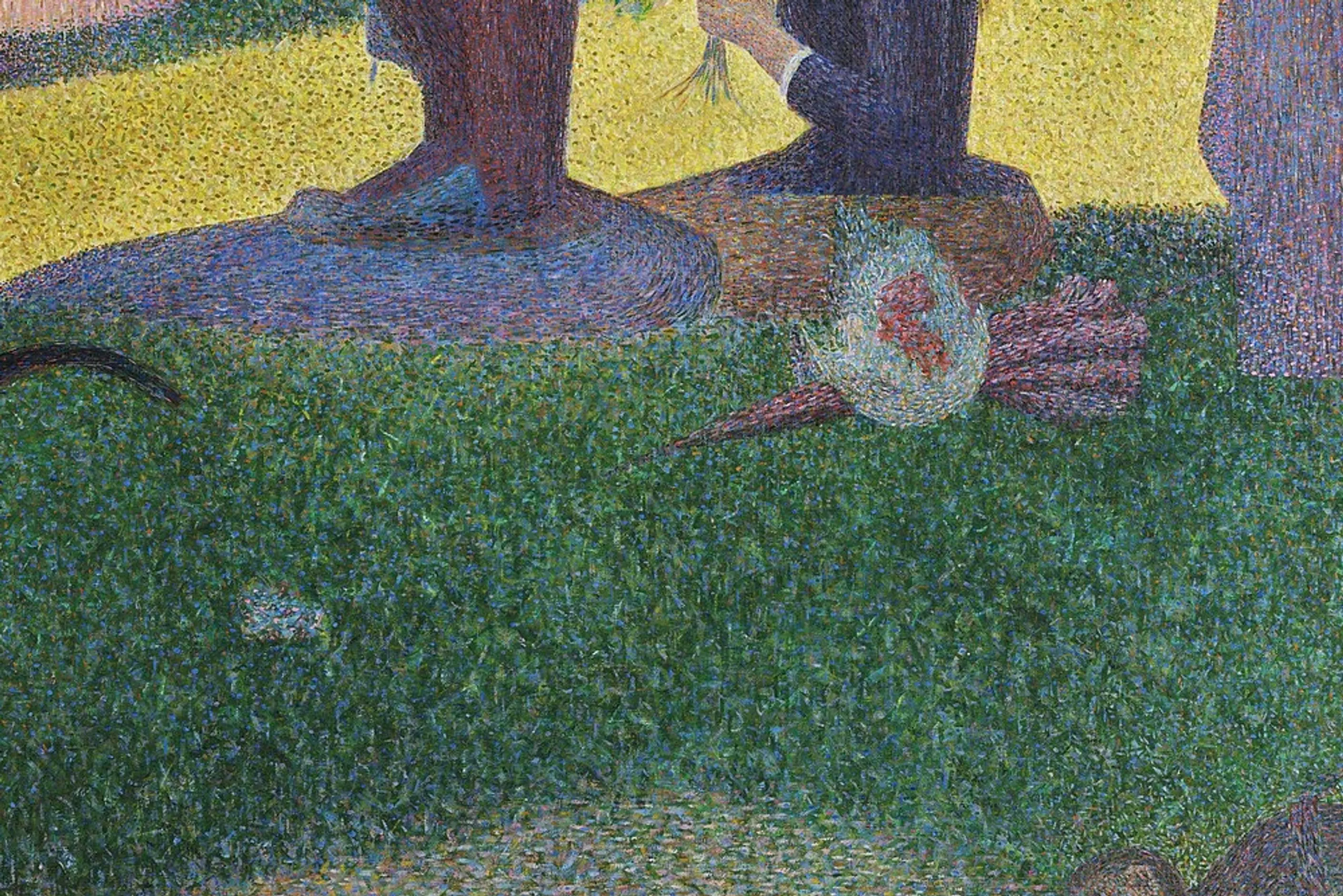 Extreme close up of painted grass showing individual dots of green, blue and orange paint