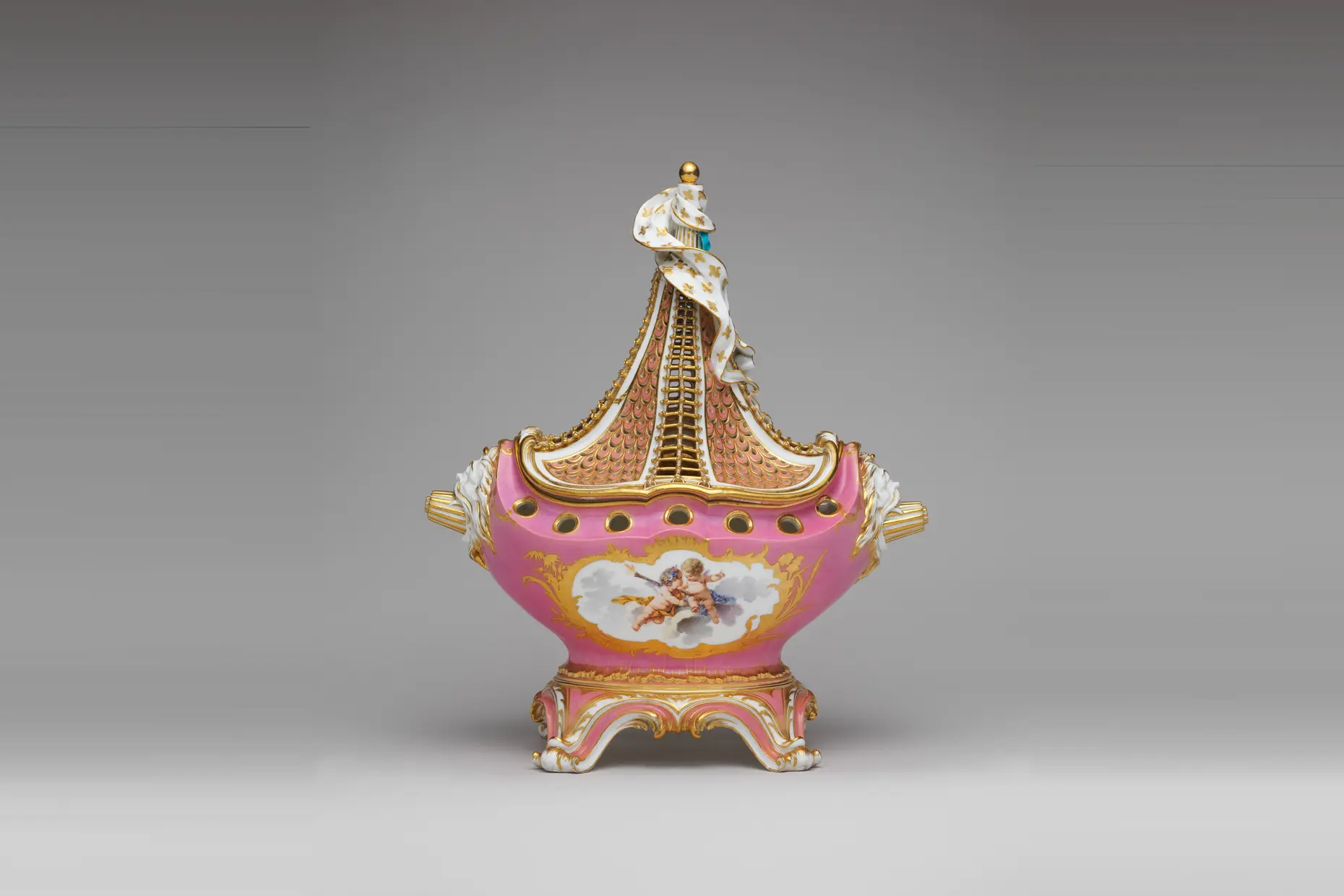 An eighteenth-century Sèvres pot-pourri vase in bright pink porcelain with gilded trim and a painted cherub panel