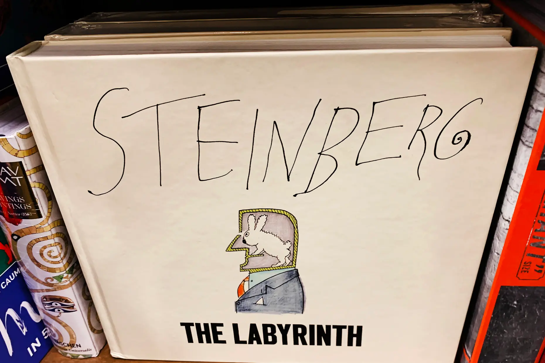 The cover of Saul Steinberg's book The Labyrinth, his name hand-lettered above a small drawing of a man with a rabbit in his head