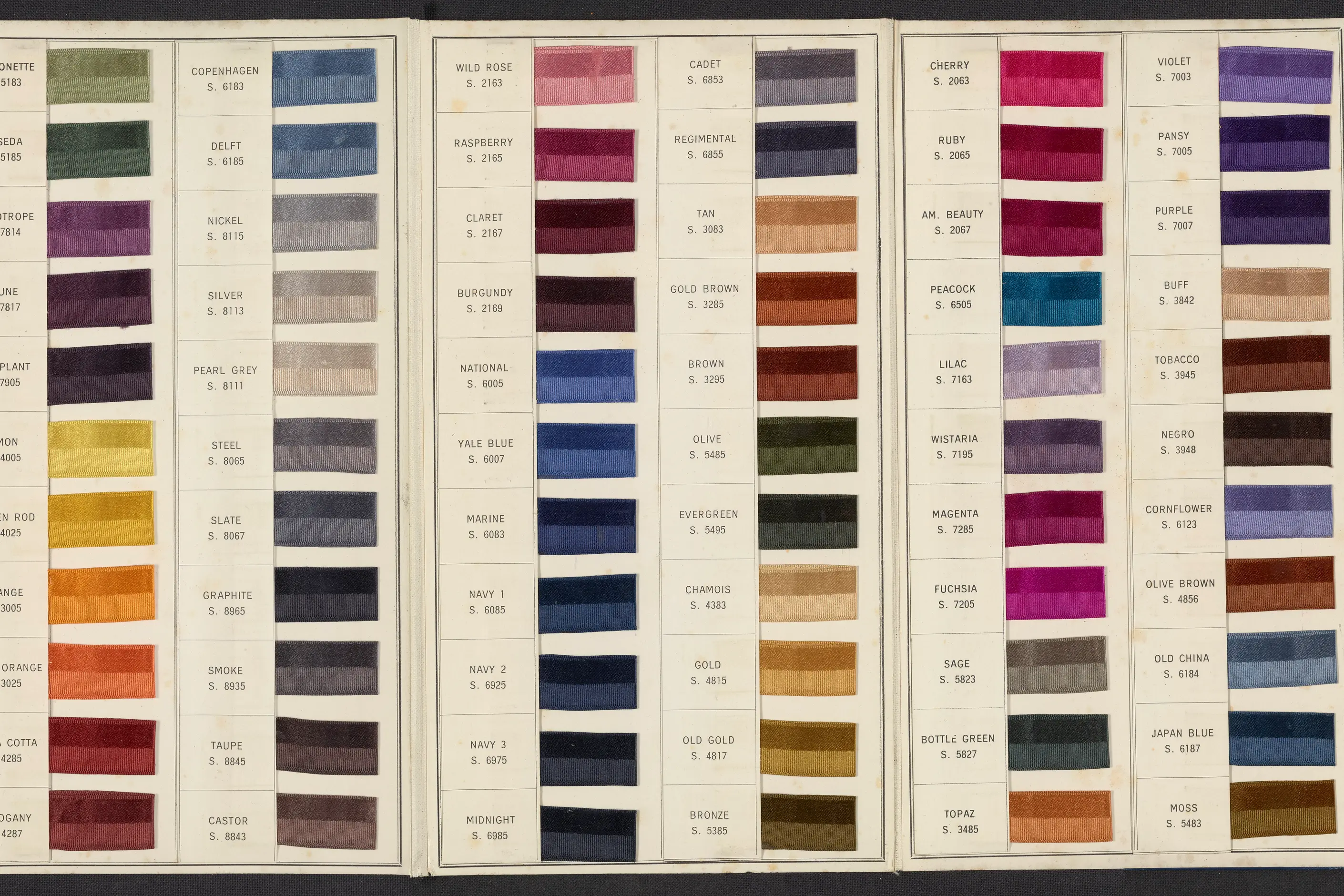 Rows of silk ribbon swatches in blues, reds, greens and golds, each with a printed name and standard number